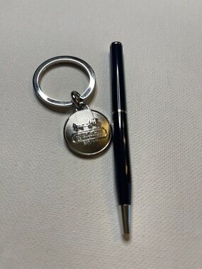 Coach Leatherware Brushed Silver Medallion Keyring with a Black Coach Pen